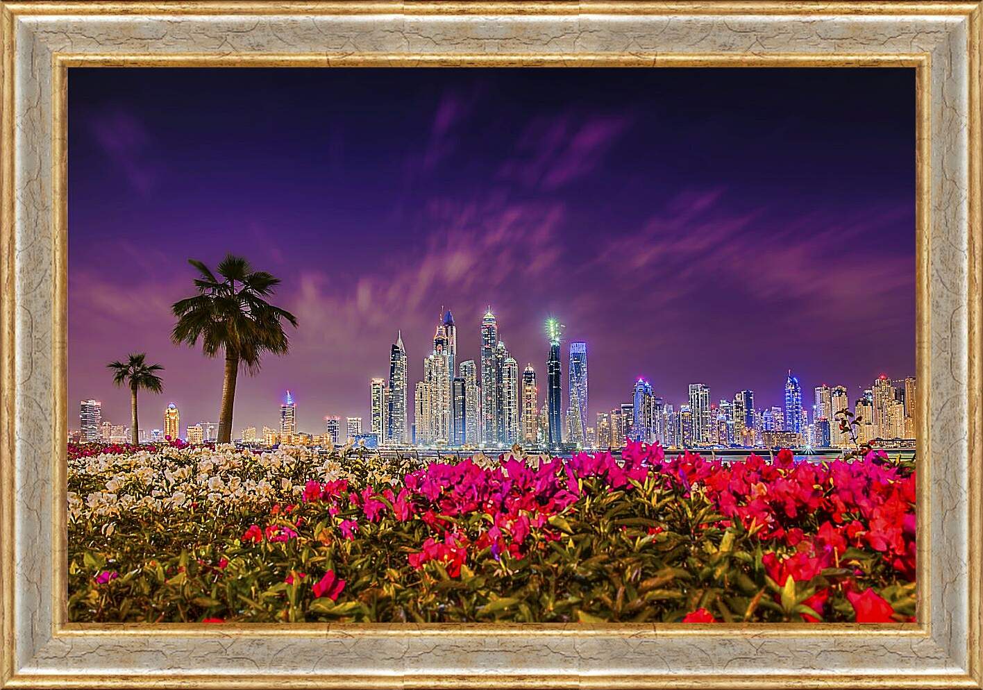 Картина в раме - Клумбы цветов на фоне пальм и города. Дубай